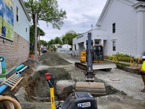Heavy equipment being used to dig up a road